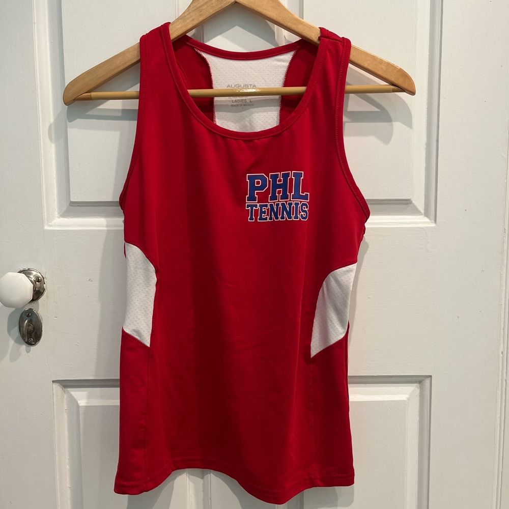 Red athletic tank top with white strip down the back that says PHL TENNIS